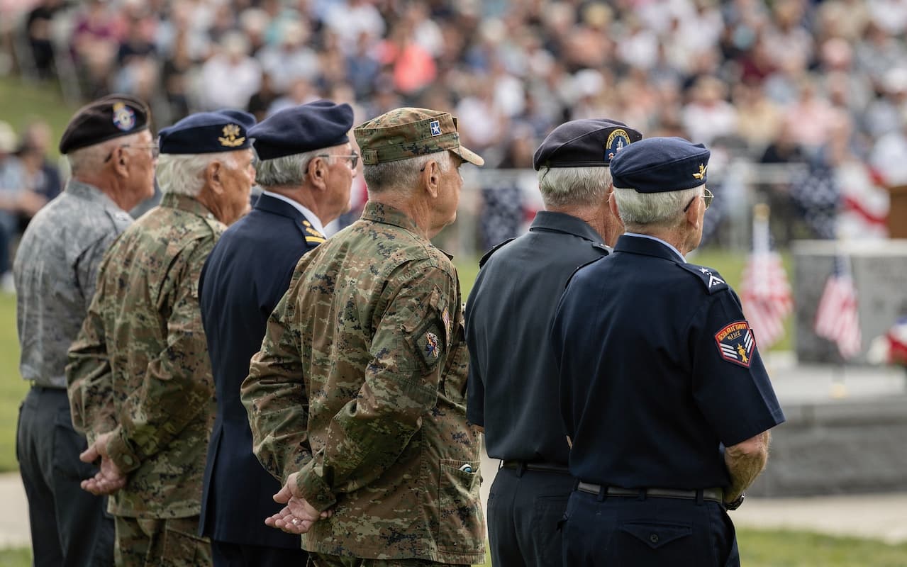 An American flag waving against a blue sky, representing the patriotic values at the heart of Red White and Give